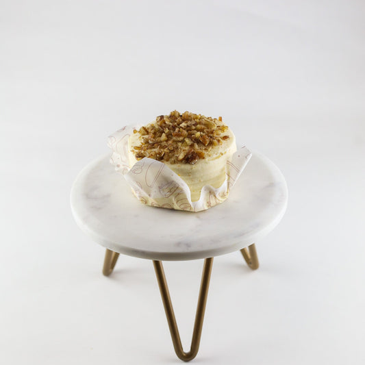 Classic carrot cake with cream cheese frosting and cinnamon — available for pickup at Shelíss Bakeshop