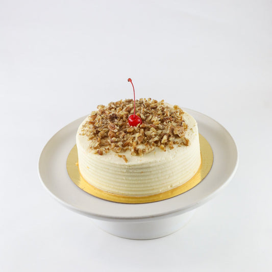 Classic carrot cake with cream cheese frosting and cinnamon — available for pickup at Shelíss Bakeshop
