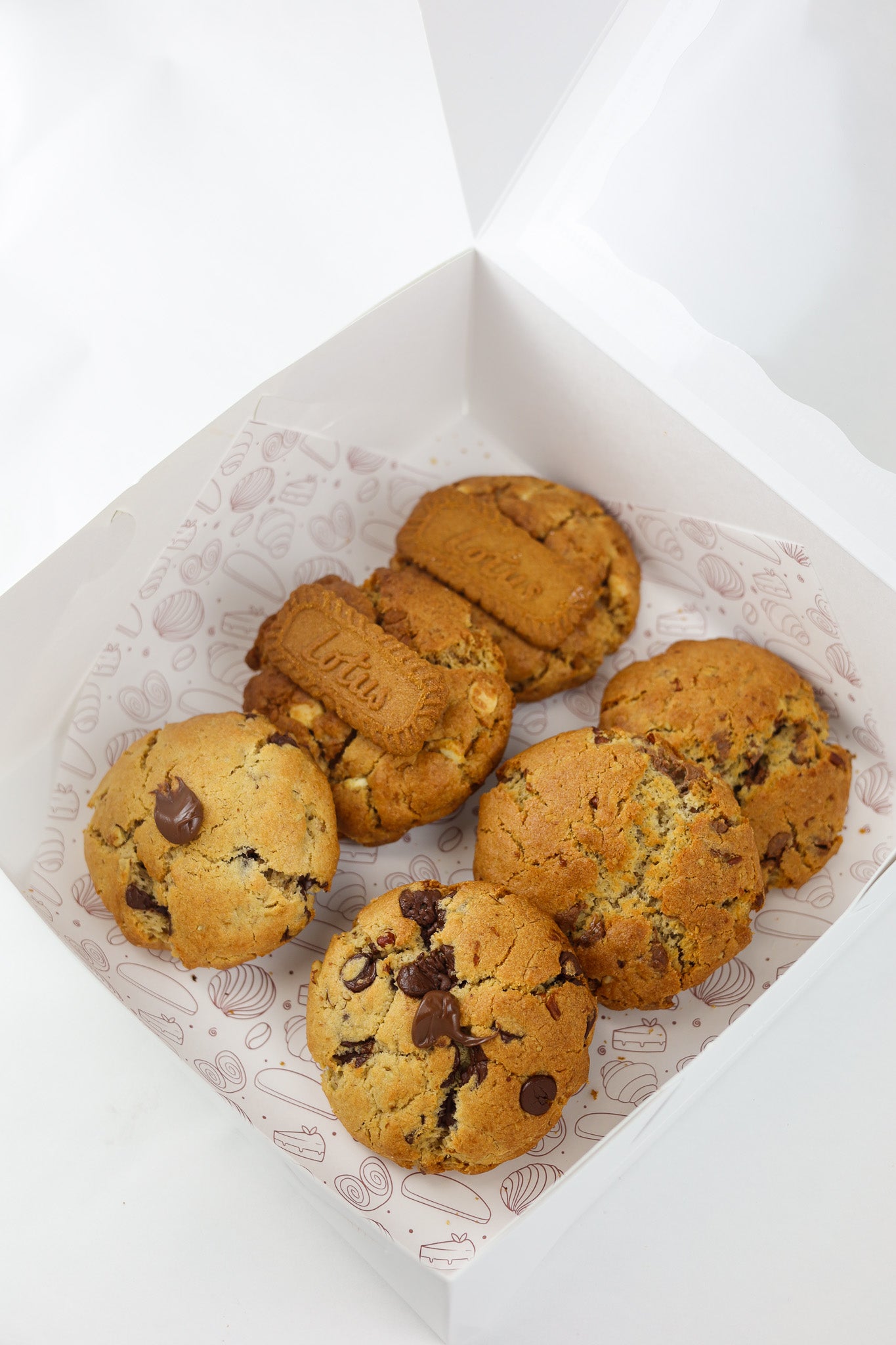 Chunky NYC-style cookies in assorted flavors: Oreo, Nutella, Biscoff, and walnut chocolate chip — fresh from Shelíss Bakeshop.