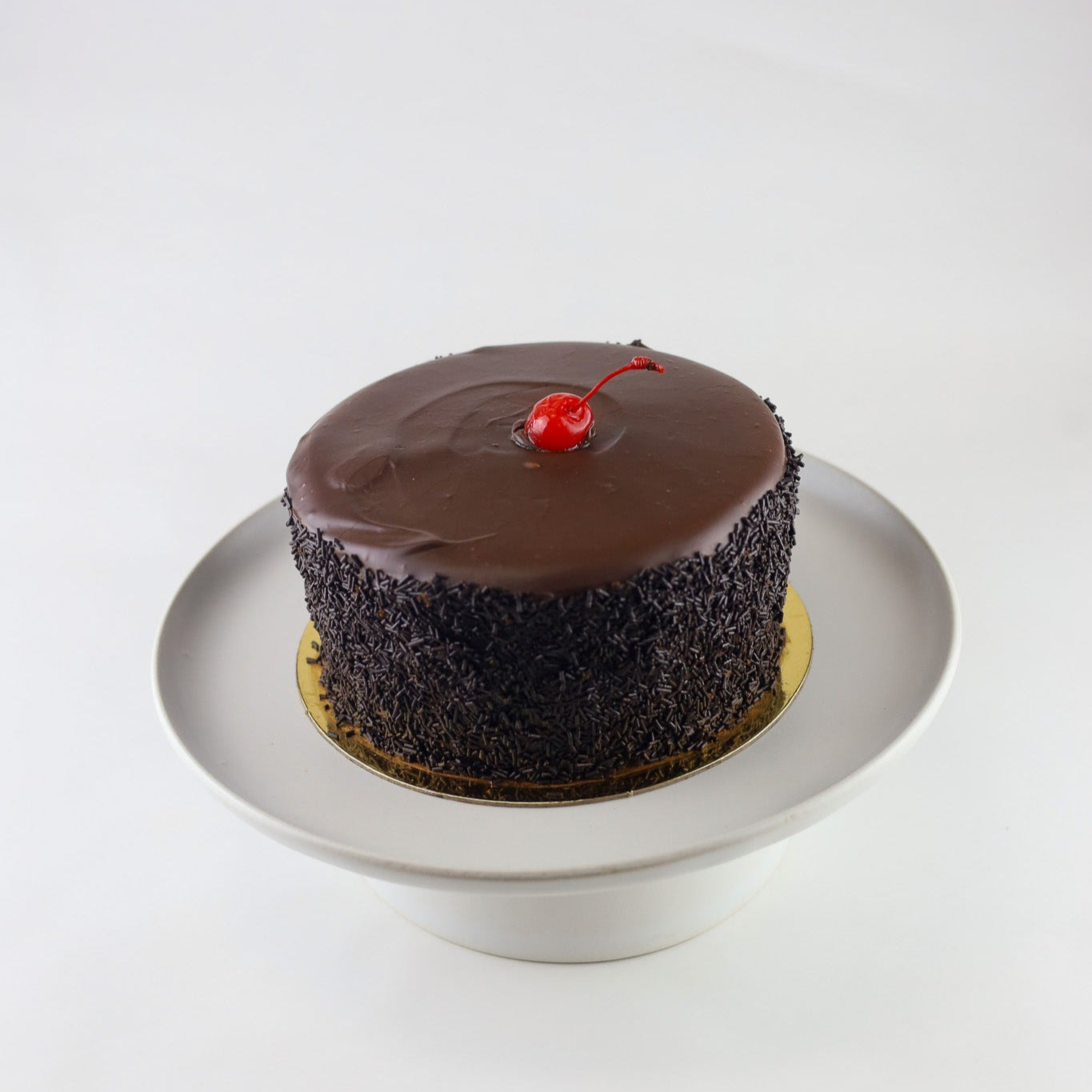 Triple chocolate cake with white chocolate mousse filling and ganache topping — available for pickup at Shelíss Bakeshop