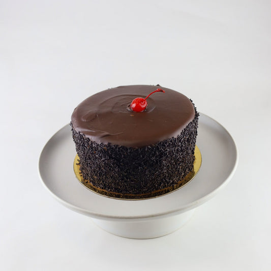 Triple chocolate cake with white chocolate mousse filling and ganache topping — available for pickup at Shelíss Bakeshop